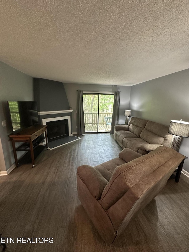 365 Moytoy Rd Unit 103, Crab Orchard, TN 37723 - living room featuring dark wood-type flooring, a fireplace with raised hearth, and a textured ceiling