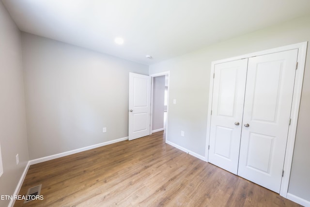 116 Jonathan Ln, Oak Ridge, TN 37830 - unfurnished bedroom with wood finished floors, a closet, and baseboards