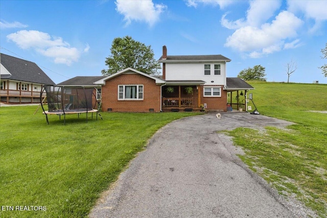 573 Patterson Rd, Harrogate, TN 37752 - back of property featuring a trampoline, a porch, brick siding, a chimney, and driveway