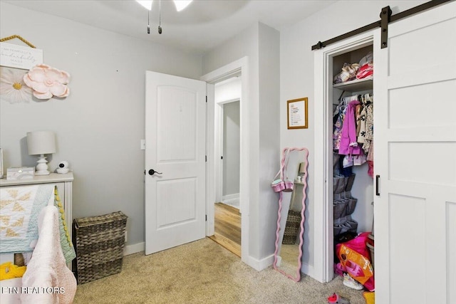 573 Patterson Rd, Harrogate, TN 37752 - bedroom with light colored carpet, baseboards, and a barn door