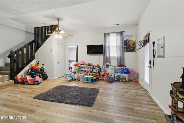 573 Patterson Rd, Harrogate, TN 37752 - game room featuring electric panel, wood finished floors, a ceiling fan, and wood walls