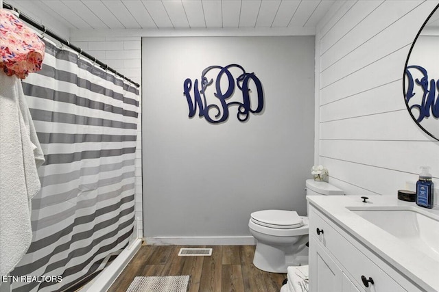 573 Patterson Rd, Harrogate, TN 37752 - full bathroom with toilet, wooden walls, wood finished floors, vanity, and a shower with curtain