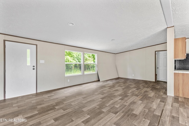 2000 Velma Rd, Athens, TN 37303 - unfurnished living room featuring wood finished floors and a textured ceiling
