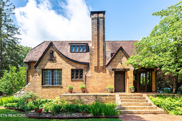 109 Willard St, Maryville, TN 37803 - tudor-style house with a chimney and brick siding