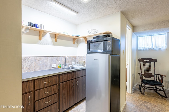 109 Willard St, Maryville, TN 37803 - kitchen featuring freestanding refrigerator, open shelves, black microwave, a sink, and a textured ceiling