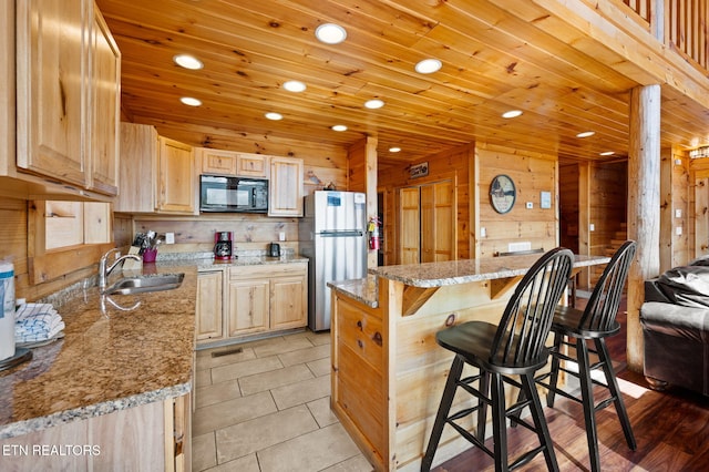 2456 Hackberry Dr, Sevierville, TN 37862 - kitchen featuring black microwave, freestanding refrigerator, a sink, light brown cabinetry, and recessed lighting