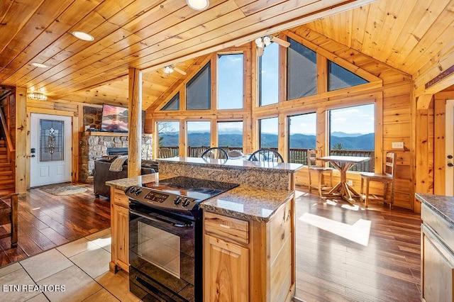 2456 Hackberry Dr, Sevierville, TN 37862 - kitchen with black range with electric cooktop, lofted ceiling, wooden ceiling, a mountain view, and open floor plan