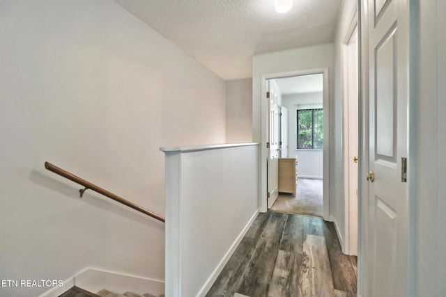 99 Wilshire Heights Dr Unit 99, Crossville, TN 38558 - hall with an upstairs landing, dark wood finished floors, baseboards, and a textured ceiling