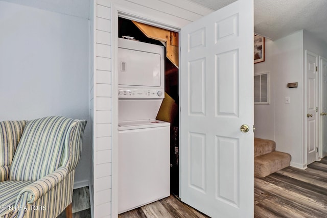 99 Wilshire Heights Dr Unit 99, Crossville, TN 38558 - laundry room with stacked washer and clothes dryer, wood finished floors, and baseboards