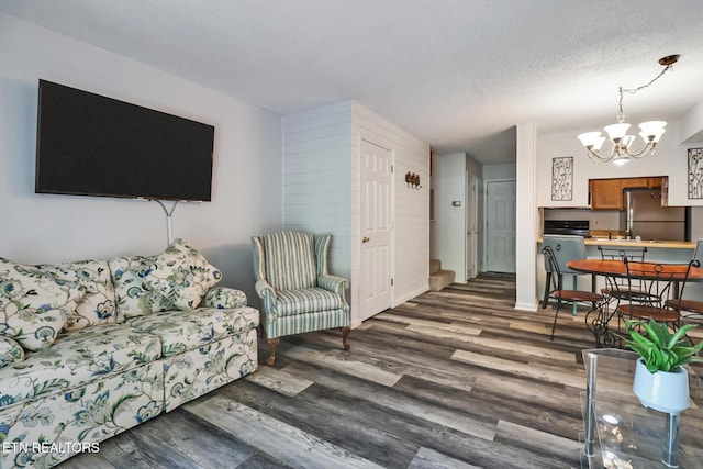 99 Wilshire Heights Dr Unit 99, Crossville, TN 38558 - living area featuring a chandelier, wood finished floors, a textured ceiling, and baseboards