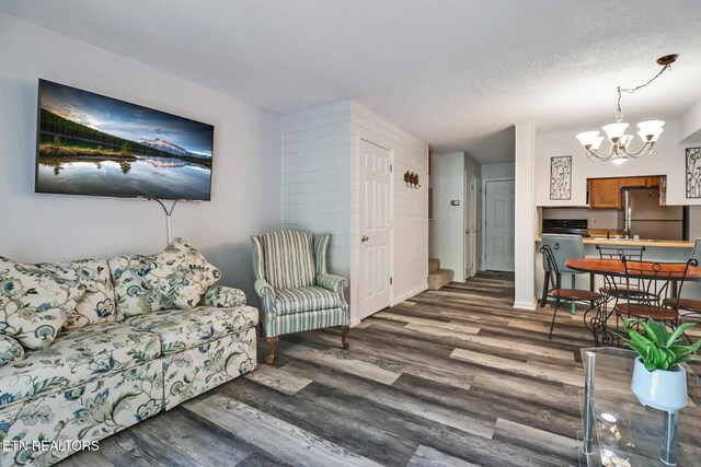 99 Wilshire Heights Dr Unit 99, Crossville, TN 38558 - living area featuring a chandelier, wood finished floors, a textured ceiling, and baseboards