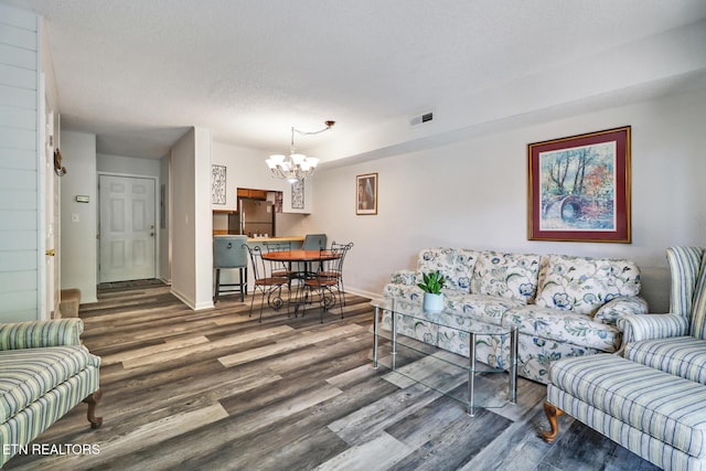 99 Wilshire Heights Dr Unit 99, Crossville, TN 38558 - living room with wood finished floors, a chandelier, baseboards, and a textured ceiling