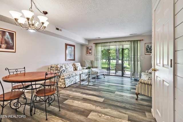 99 Wilshire Heights Dr Unit 99, Crossville, TN 38558 - dining room featuring a textured ceiling, a chandelier, and wood finished floors