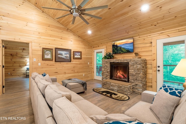 1646 Misty Hollow Way, Gatlinburg, TN 37738 - living room featuring vaulted ceiling, wooden ceiling, wood finished floors, a ceiling fan, and a stone fireplace