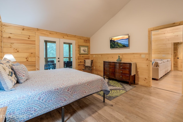 1646 Misty Hollow Way, Gatlinburg, TN 37738 - bedroom featuring french doors, wooden walls, access to exterior, wood finished floors, and wainscoting