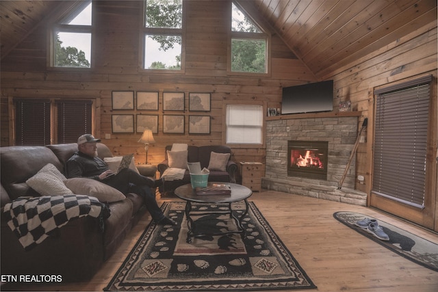 1646 Misty Hollow Way, Gatlinburg, TN 37738 - living room with high vaulted ceiling, wood ceiling, wood walls, wood finished floors, and a stone fireplace