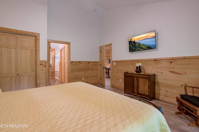 1646 Misty Hollow Way, Gatlinburg, TN 37738 - bedroom with wood finished floors, a wainscoted wall, high vaulted ceiling, and wooden walls