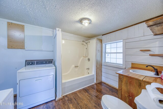 7250 Rutledge Pike, Knoxville, TN 37924 - full bathroom featuring washer / dryer, a sink, toilet, wood finished floors, and a textured ceiling