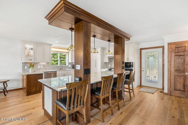 3728 Lighthouse Way, Sevierville, TN 37876 - kitchen featuring stainless steel dishwasher, backsplash, light wood-type flooring, light stone counters, and crown molding