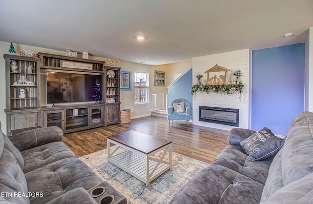 812 Greene Meadow Dr, Talbott, TN 37877 - living area with a glass covered fireplace, wood finished floors, and baseboards