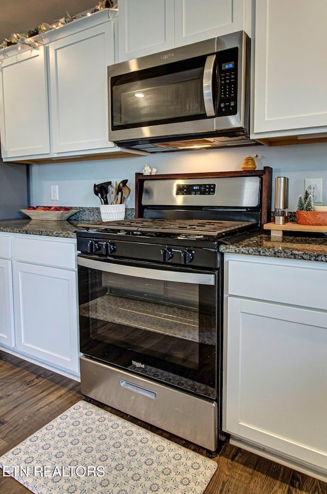 812 Greene Meadow Dr, Talbott, TN 37877 - kitchen featuring stainless steel appliances, dark wood-style flooring, white cabinetry, and dark stone counters