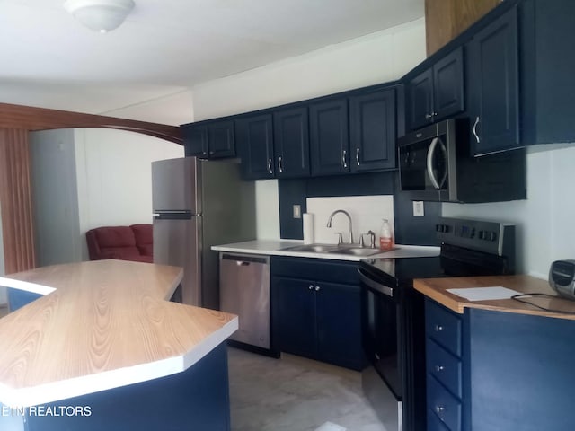 915 Porter Kite Rd, Mohawk, TN 37810 - kitchen with appliances with stainless steel finishes, blue cabinetry, a sink, light countertops, and arched walkways
