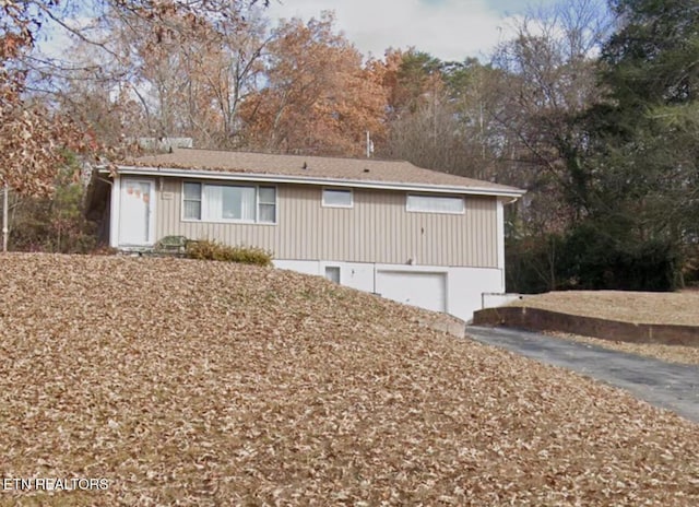 9921 Higdon Dr, Knoxville, TN 37931 - view of front of house featuring an attached garage, driveway, and view of scattered trees