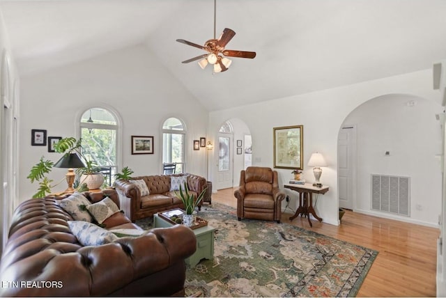 4151 Cave Springs Rd, Tazewell, TN 37879 - living area with arched walkways, a ceiling fan, wood finished floors, and high vaulted ceiling