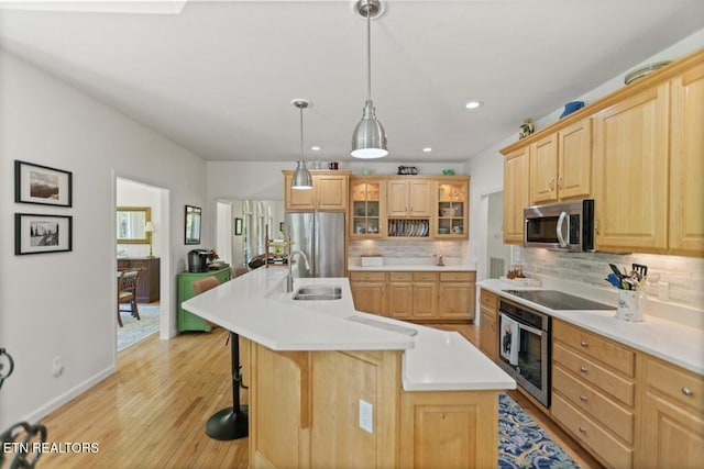 4151 Cave Springs Rd, Tazewell, TN 37879 - kitchen featuring a sink, stainless steel appliances, tasteful backsplash, light brown cabinetry, and light countertops