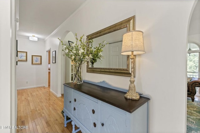 4151 Cave Springs Rd, Tazewell, TN 37879 - hallway featuring arched walkways, light wood-style floors, ornamental molding, and baseboards