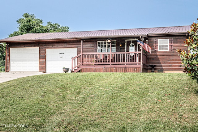 2277 Old Wolf River Rd, Jamestown, TN 38556 - view of front of property featuring a porch, a metal roof, a front yard, concrete driveway, and an attached garage