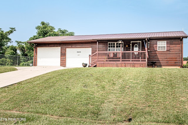 2277 Old Wolf River Rd, Jamestown, TN 38556 - view of front of property featuring a garage, driveway, a metal roof, and covered porch