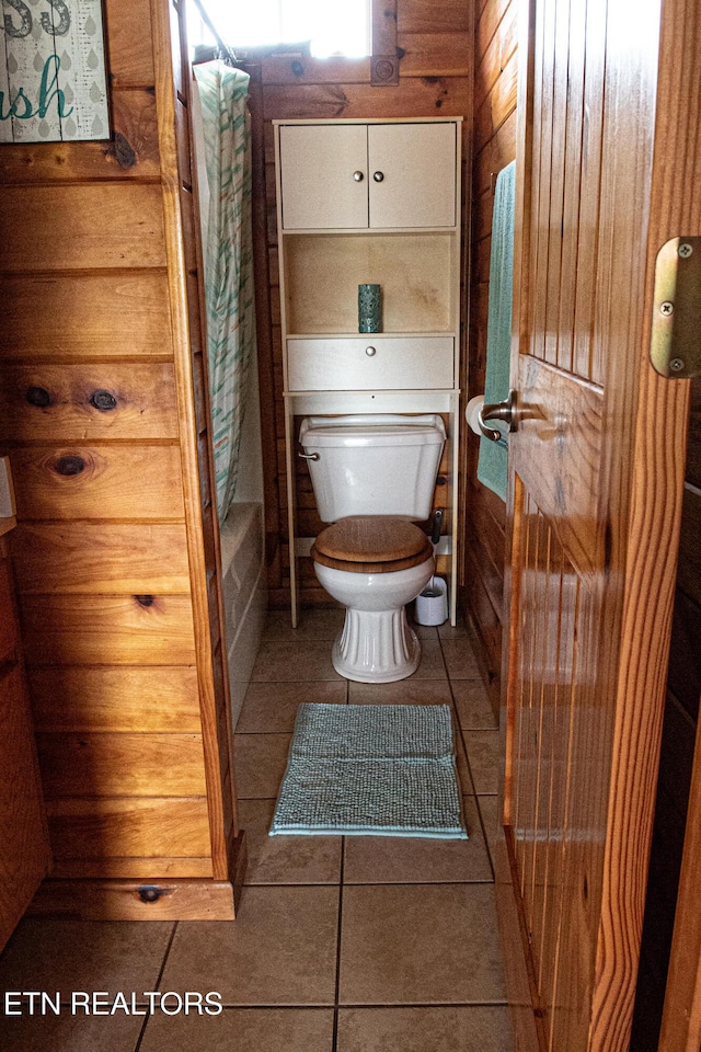 2277 Old Wolf River Rd, Jamestown, TN 38556 - bathroom with tile patterned flooring, shower / tub combo with curtain, and wood walls