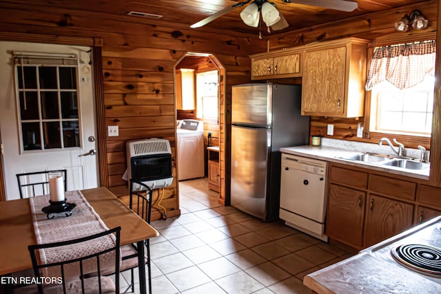 2277 Old Wolf River Rd, Jamestown, TN 38556 - kitchen featuring washer / clothes dryer, white dishwasher, heating unit, freestanding refrigerator, and plenty of natural light