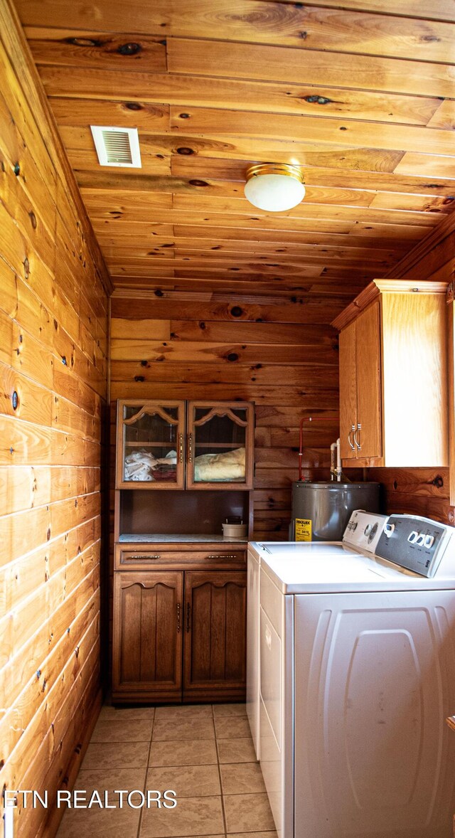 2277 Old Wolf River Rd, Jamestown, TN 38556 - laundry area with washing machine and dryer, cabinet space, wooden ceiling, light tile patterned floors, and wooden walls