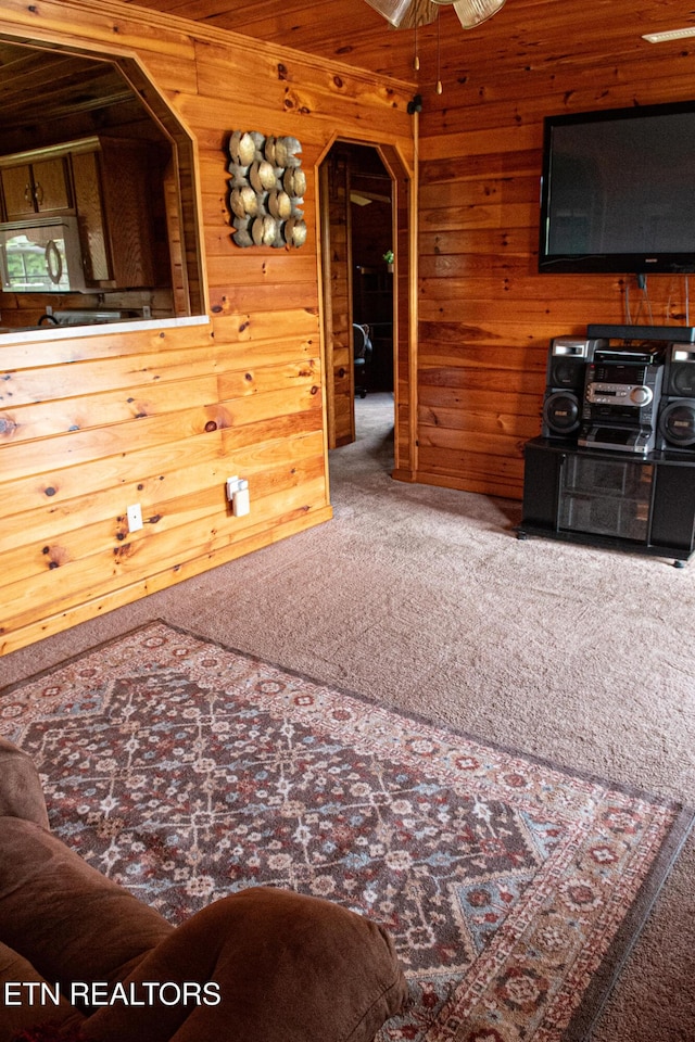 2277 Old Wolf River Rd, Jamestown, TN 38556 - living area featuring carpet flooring, wooden walls, and ceiling fan