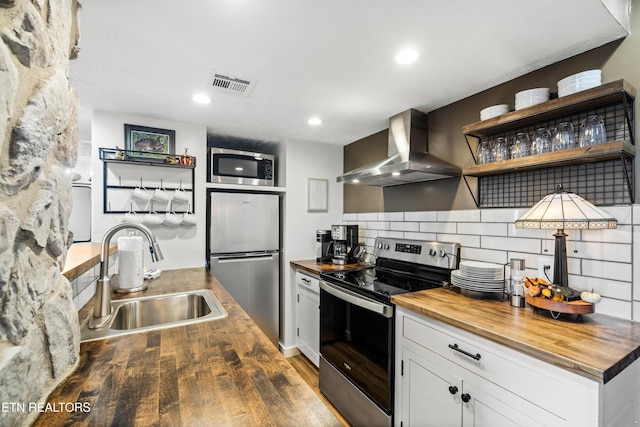 3710 Weber Rd Unit E107, Gatlinburg, TN 37738 - kitchen with butcher block counters, appliances with stainless steel finishes, wall chimney range hood, a sink, and recessed lighting