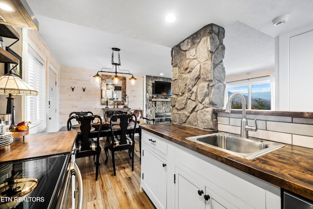 3710 Weber Rd Unit E107, Gatlinburg, TN 37738 - kitchen featuring wooden counters, a sink, light wood finished floors, white cabinets, and electric range