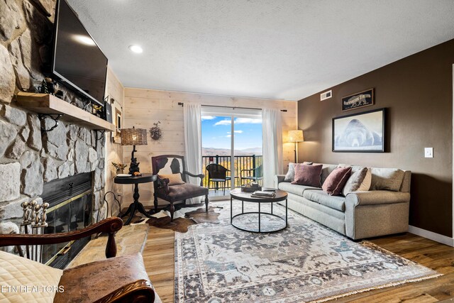 3710 Weber Rd Unit E107, Gatlinburg, TN 37738 - living room with wood finished floors, a fireplace, baseboards, and a textured ceiling