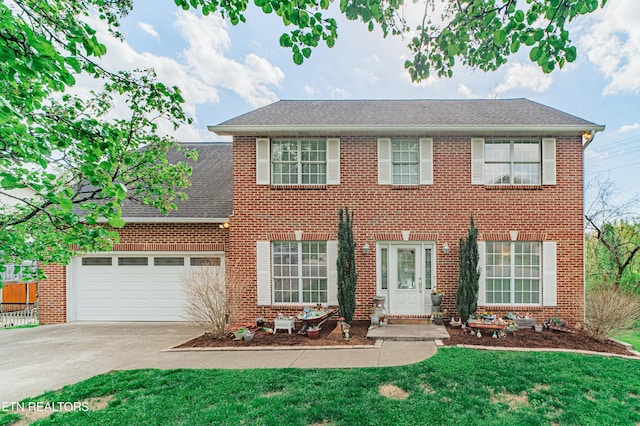 117 Maltese Ln, Oak Ridge, TN 37830 - colonial home featuring driveway, brick siding, a garage, and a front lawn