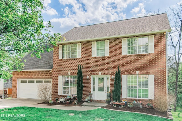 117 Maltese Ln, Oak Ridge, TN 37830 - colonial house featuring driveway, roof with shingles, brick siding, and a garage