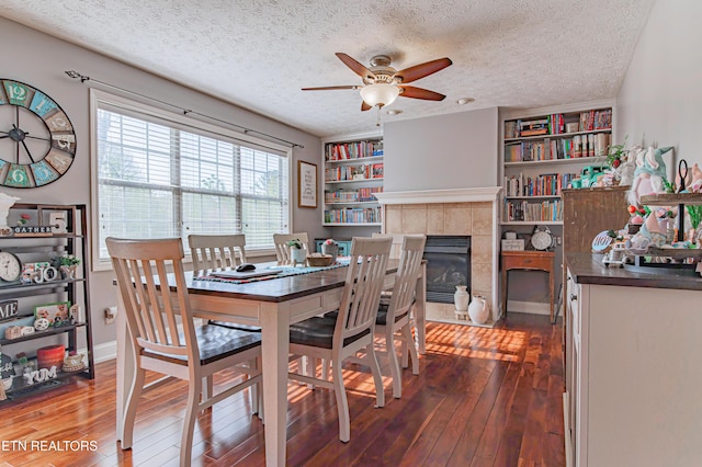 117 Maltese Ln, Oak Ridge, TN 37830 - dining area featuring dark wood-type flooring, a ceiling fan, a textured ceiling, a tile fireplace, and built in features