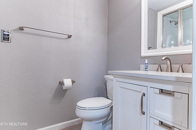 117 Maltese Ln, Oak Ridge, TN 37830 - bathroom featuring vanity, toilet, a textured wall, and wood finished floors