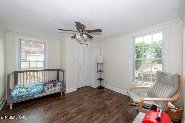 201 Kingston St, Lenoir City, TN 37771 - bedroom featuring dark wood-type flooring, crown molding, baseboards, a ceiling fan, and a closet