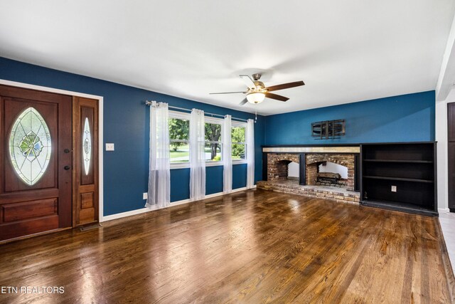 9005 Carlton Cir, Knoxville, TN 37922 - unfurnished living room with a ceiling fan, wood finished floors, a fireplace, and baseboards