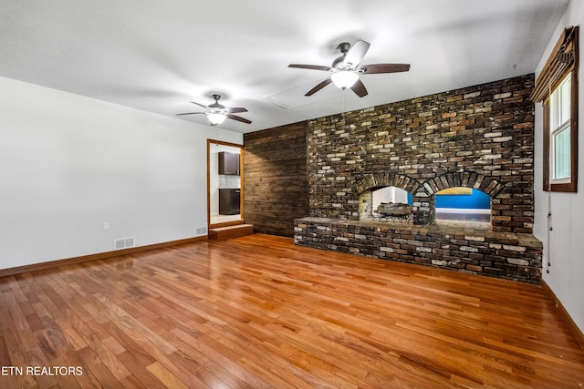 9005 Carlton Cir, Knoxville, TN 37922 - unfurnished living room featuring a ceiling fan, wood-type flooring, baseboards, and wooden walls