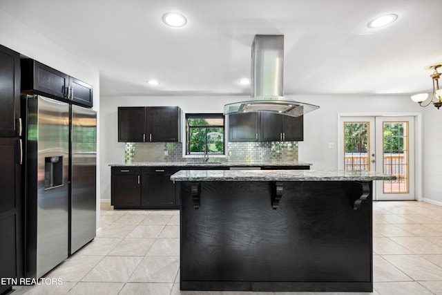 9005 Carlton Cir, Knoxville, TN 37922 - kitchen featuring stainless steel fridge with ice dispenser, island range hood, tasteful backsplash, light tile patterned floors, and a sink