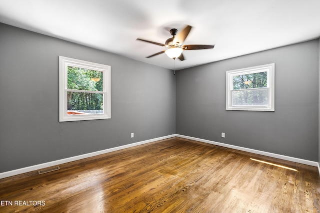 9005 Carlton Cir, Knoxville, TN 37922 - unfurnished room featuring plenty of natural light, ceiling fan, wood finished floors, and baseboards