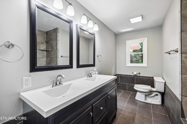 9005 Carlton Cir, Knoxville, TN 37922 - full bath with toilet, double vanity, tile patterned flooring, tile walls, and a wainscoted wall