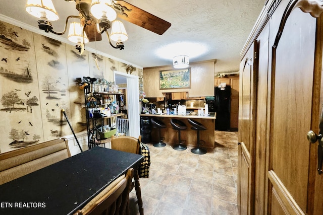 2645 Mountain View Dr, Morristown, TN 37814 - kitchen featuring crown molding, a peninsula, a textured ceiling, and freestanding refrigerator